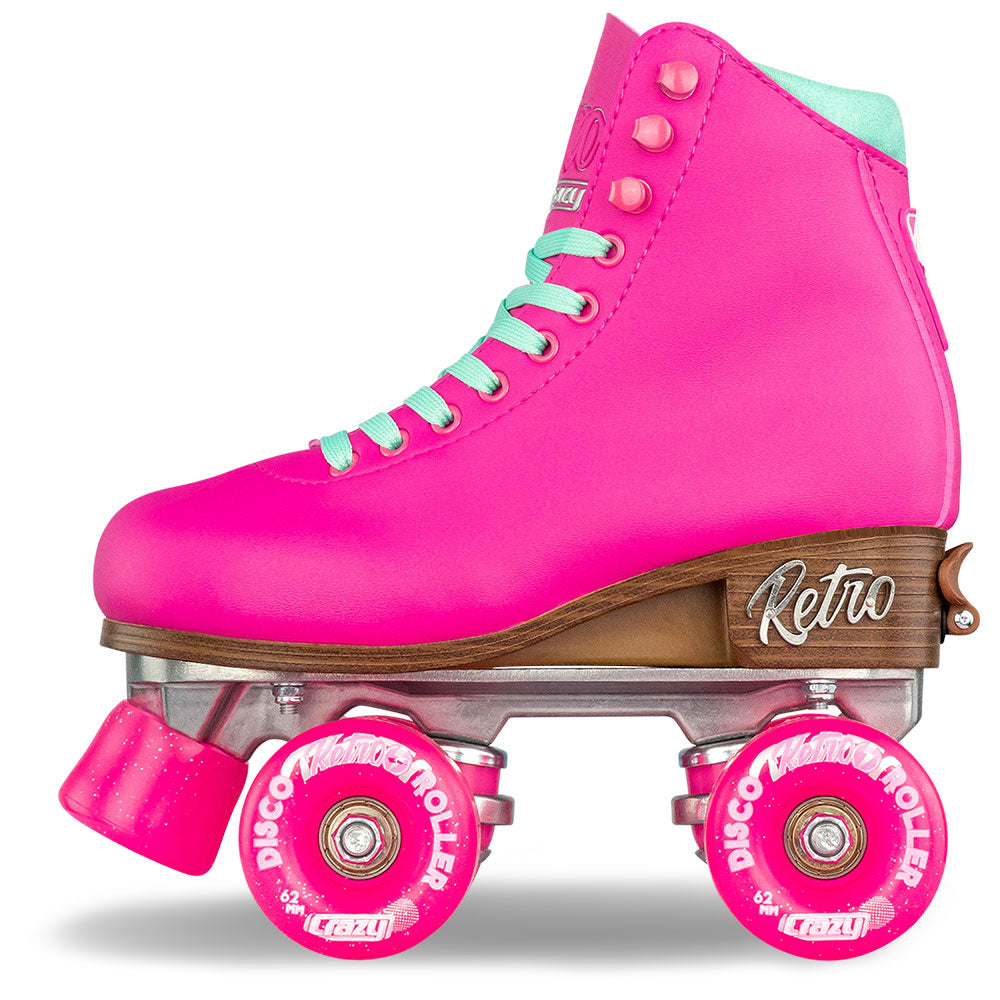 Pink retro roller skates with wooden slide and pink wheels on a white background